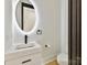 Elegant powder room with a floating vanity and illuminated mirror at 5700 Mcwhorter Rd, Waxhaw, NC 28173