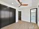 Modern bedroom with dark closet doors and ensuite bathroom at 5700 Mcwhorter Rd, Waxhaw, NC 28173