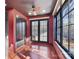 Red-walled bedroom with hardwood floors, large windows, and closet at 5700 Mcwhorter Rd, Waxhaw, NC 28173