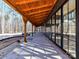 Long covered porch with wooden beams and concrete flooring at 5700 Mcwhorter Rd, Waxhaw, NC 28173