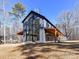 Modern barn-style home with large windows and covered porch at 5700 Mcwhorter Rd, Waxhaw, NC 28173