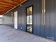 Dark siding with modern door and wood accents at 5700 Mcwhorter Rd, Waxhaw, NC 28173