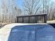 Three-car garage with modern glass garage doors at 5700 Mcwhorter Rd, Waxhaw, NC 28173