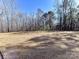 Open grassy yard with cleared trees at 5700 Mcwhorter Rd, Waxhaw, NC 28173