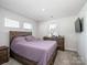 Cozy carpeted bedroom with natural light and wooden furniture at 571 Palmarosa St # 130, Fort Mill, SC 29715