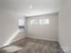 Carpeted bedroom bathed in natural light from two windows at 571 Palmarosa St # 130, Fort Mill, SC 29715