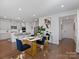 Bright dining area with modern table, bar stool seating, and hardwood floors at 571 Palmarosa St # 130, Fort Mill, SC 29715