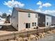 Exterior view of a house featuring a sliding glass door, small patio, and a black fence at 571 Palmarosa St # 130, Fort Mill, SC 29715