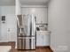 Stainless steel refrigerator and coffee bar area feature in this kitchen with gray cabinets at 571 Palmarosa St # 130, Fort Mill, SC 29715