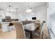 Open dining area with seating for four, looking into living room and kitchen at 693 Candela Ct, York, SC 29745