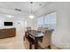 Bright dining area features a table with bench seating near living room at 693 Candela Ct, York, SC 29745