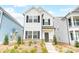 Two-story white house with black shutters, stone accents, and landscaping at 693 Candela Ct, York, SC 29745