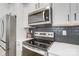 Modern kitchen with white cabinets, stainless steel appliances, and island at 693 Candela Ct, York, SC 29745