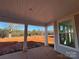 Back porch view of the backyard with red dirt and trees at 8704 Sherrills Ford Rd, Sherrills Ford, NC 28673