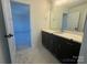 Bathroom featuring dark cabinets, dual mirrors, and white counter tops at 8704 Sherrills Ford Rd, Sherrills Ford, NC 28673