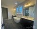 Modern bathroom featuring dual vanities, a freestanding tub, and stylish lighting fixtures at 8704 Sherrills Ford Rd, Sherrills Ford, NC 28673