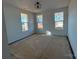 Bright bedroom with three windows and a modern ceiling light fixture at 8704 Sherrills Ford Rd, Sherrills Ford, NC 28673