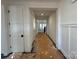 Bright hallway featuring white trim and doors and a view of the stairs at 8704 Sherrills Ford Rd, Sherrills Ford, NC 28673