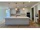 Kitchen features a large island, white cabinets and pendant lighting at 8704 Sherrills Ford Rd, Sherrills Ford, NC 28673