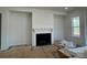 Living room featuring a fireplace and a large window at 8704 Sherrills Ford Rd, Sherrills Ford, NC 28673