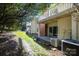 Home's back patio with access from sliding glass doors and a deck above at 9427 S Vicksburg Park Ct, Charlotte, NC 28210