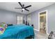 Bedroom with teal bedding, ceiling fan, and en-suite bathroom at 9427 S Vicksburg Park Ct, Charlotte, NC 28210