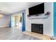 Living room with white brick fireplace and sliding doors at 9427 S Vicksburg Park Ct, Charlotte, NC 28210