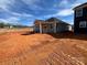 Backyard view of new construction featuring a covered patio and backyard awaiting your personal touch and landscaping at 1012 Farm Branch Ct, Indian Trail, NC 28079