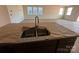 Bright kitchen featuring stainless steel sink, granite countertops, and plenty of natural light from large windows at 1012 Farm Branch Ct, Indian Trail, NC 28079