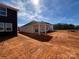 New home construction showcasing a covered patio with a large, undeveloped backyard at 1020 Farm Branch Ct, Indian Trail, NC 28079