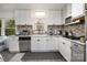 Modern white kitchen with stainless steel appliances and granite counters at 1241 Red River Rd, Rock Hill, SC 29730