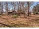 Spacious backyard with mature trees and rustic barn at 147 W Mcneely Ave, Mooresville, NC 28115