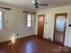 Bedroom with hardwood floors, mirrored closet and two windows at 147 W Mcneely Ave, Mooresville, NC 28115