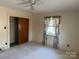 Bedroom with hardwood floors, ceiling fan and floral curtains at 147 W Mcneely Ave, Mooresville, NC 28115