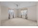 Bedroom with carpeted floor and floral curtains at 147 W Mcneely Ave, Mooresville, NC 28115