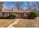 Red brick ranch house with a covered porch and landscaping at 147 W Mcneely Ave, Mooresville, NC 28115