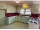 Retro kitchen with light green cabinets and red countertops at 147 W Mcneely Ave, Mooresville, NC 28115