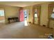 Bright living room with red door, carpet, and large windows at 147 W Mcneely Ave, Mooresville, NC 28115