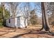 White metal shed in wooded backyard at 147 W Mcneely Ave, Mooresville, NC 28115