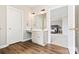 Well-lit bathroom featuring a white vanity with a view into the spacious gray Primary bedroom at 15613 Glen Miro Dr, Huntersville, NC 28078