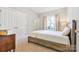 Bright bedroom featuring a wooden bed frame, neutral walls, carpet, and natural light from a window at 15613 Glen Miro Dr, Huntersville, NC 28078