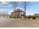 Charming Tudor style building with brick and half-timbered accents, set on a landscaped street at 15613 Glen Miro Dr, Huntersville, NC 28078