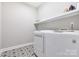 Clean laundry area with white appliances and shelving at 15613 Glen Miro Dr, Huntersville, NC 28078