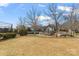 Community playground with varied play structures, benches, and mature trees in a grassy area at 15613 Glen Miro Dr, Huntersville, NC 28078