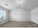 Bedroom with vaulted ceilings and a large window at 16115 Preston Knoll Ln, Charlotte, NC 28215