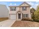 Two-story house with beige vinyl siding, a white garage door, and landscaping at 16115 Preston Knoll Ln, Charlotte, NC 28215