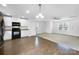 Open concept kitchen with hardwood floors and stainless steel appliances at 16115 Preston Knoll Ln, Charlotte, NC 28215