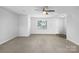 Spacious living room with neutral carpeting and a view of the entryway at 16115 Preston Knoll Ln, Charlotte, NC 28215