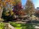 Landscaped backyard with fall foliage at 1629 Southpoint Ln, New London, NC 28127