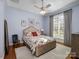 Bright bedroom with a floral bedspread and hardwood floors at 1629 Southpoint Ln, New London, NC 28127